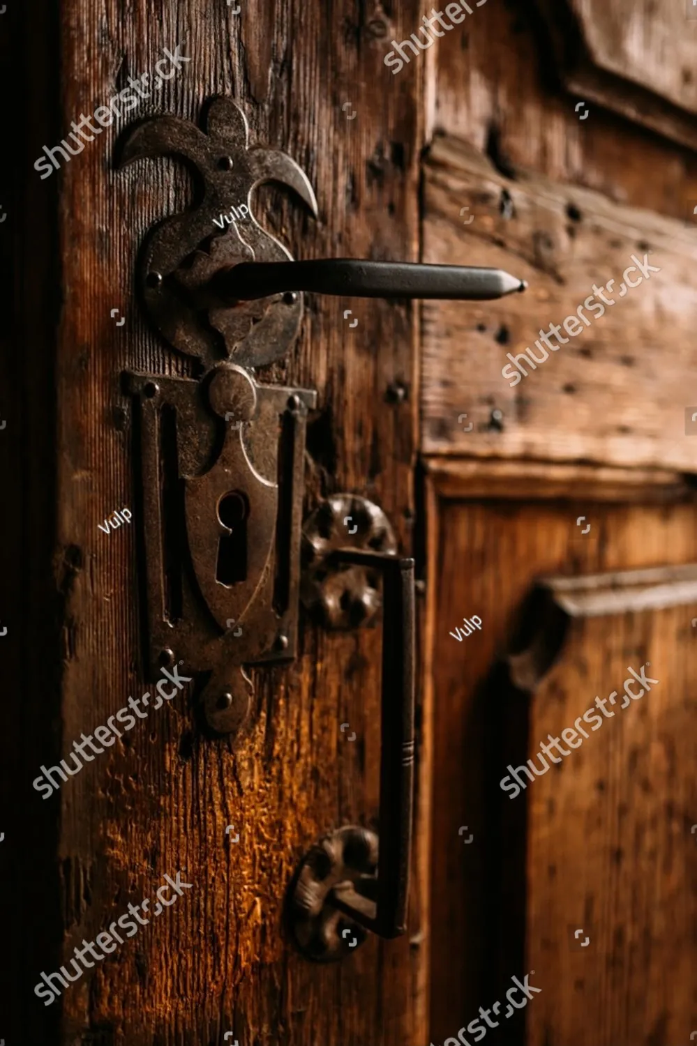 An old wooden door with an ornate iron handle
